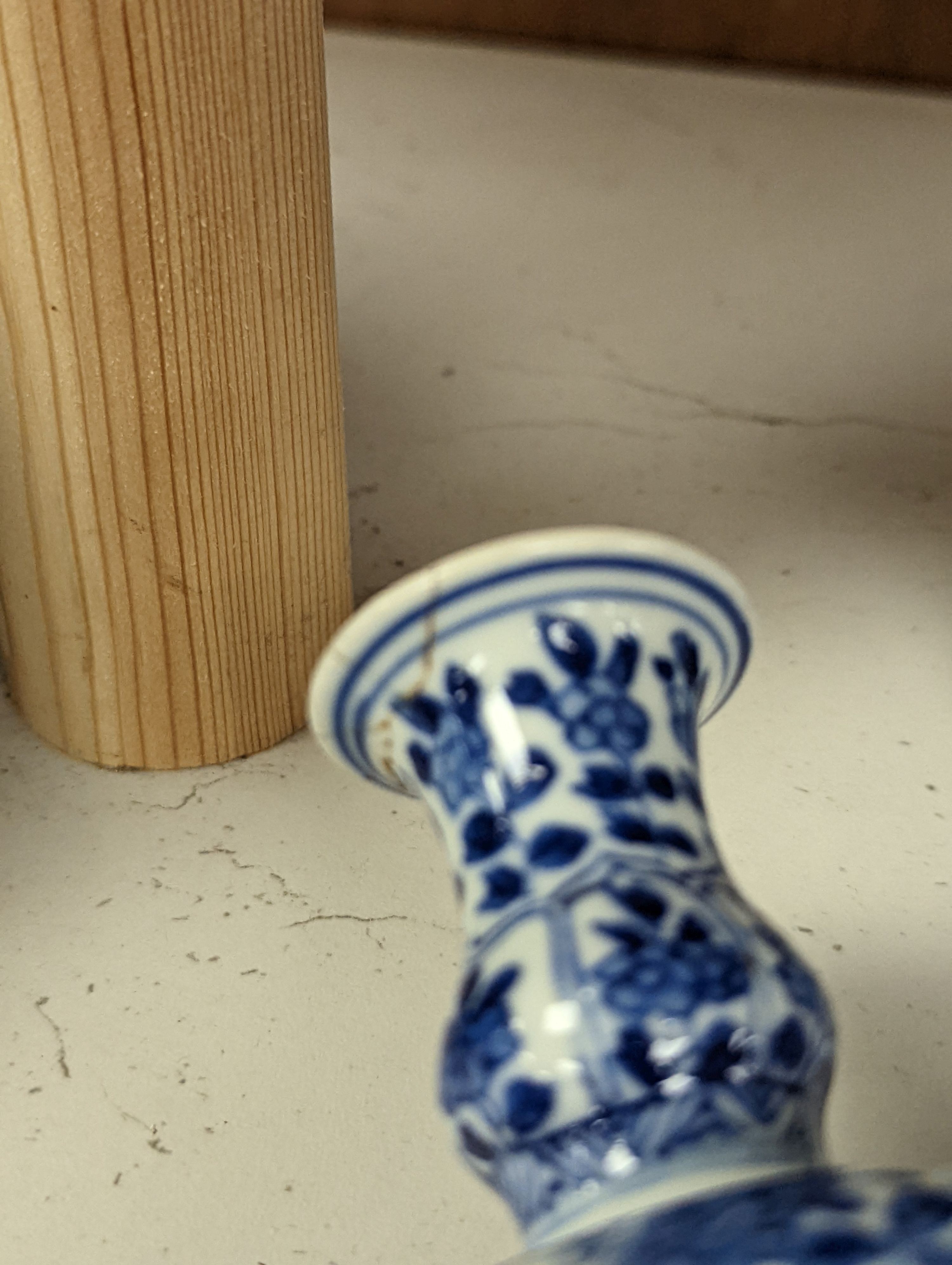 A Chinese blue and white vase and cover, Kangxi mark, 19th century, 26.5cm tall, and a Chinese Kangxi period small vase (2)